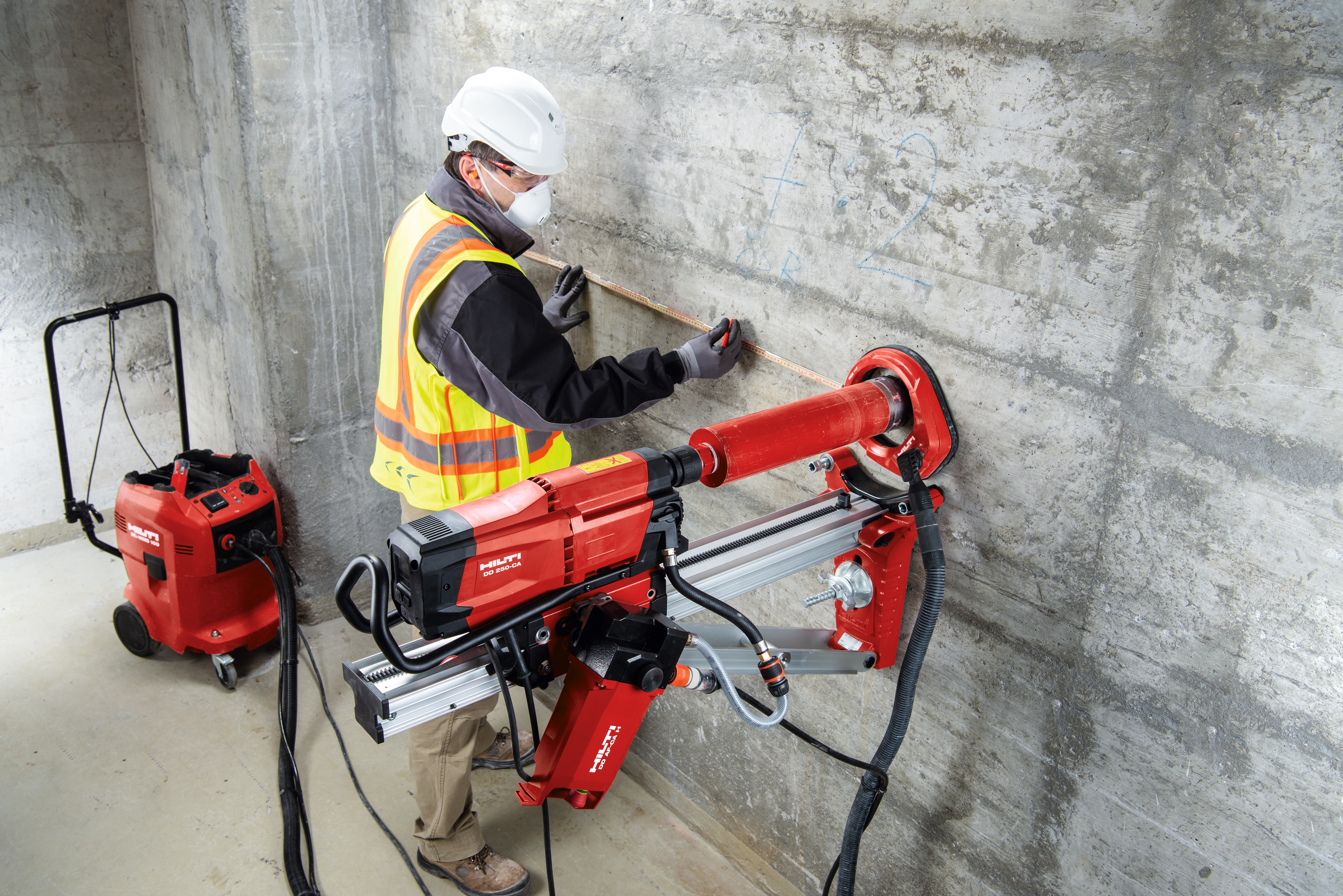 Worker on jobsite operating a diamond drill