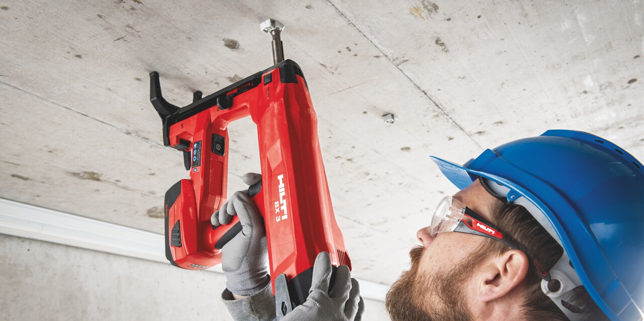 BX 3 battery-powered nailer, a virtually dust-free alternative to drilling, being used to fasten on concrete