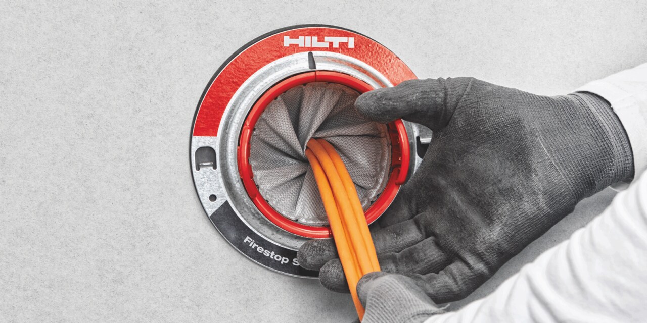 Photo of a CFS-SL Firestop sleeve being used to firestop around cables.