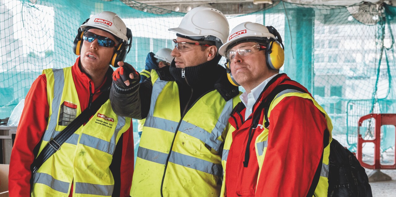 A Hilti engineer and account manager providing on-site support and consultation to a customer.
