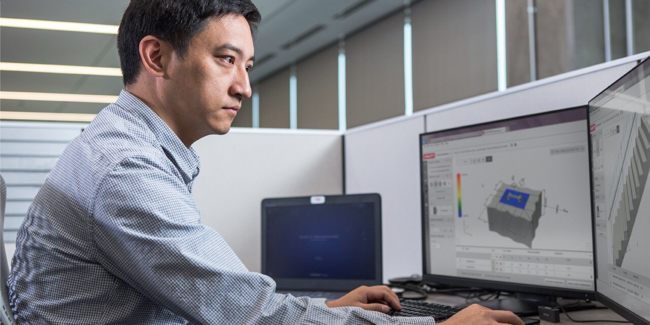 Photo of a Hilti Engineer at his desk, carrying out an engineering judgement for a customer.