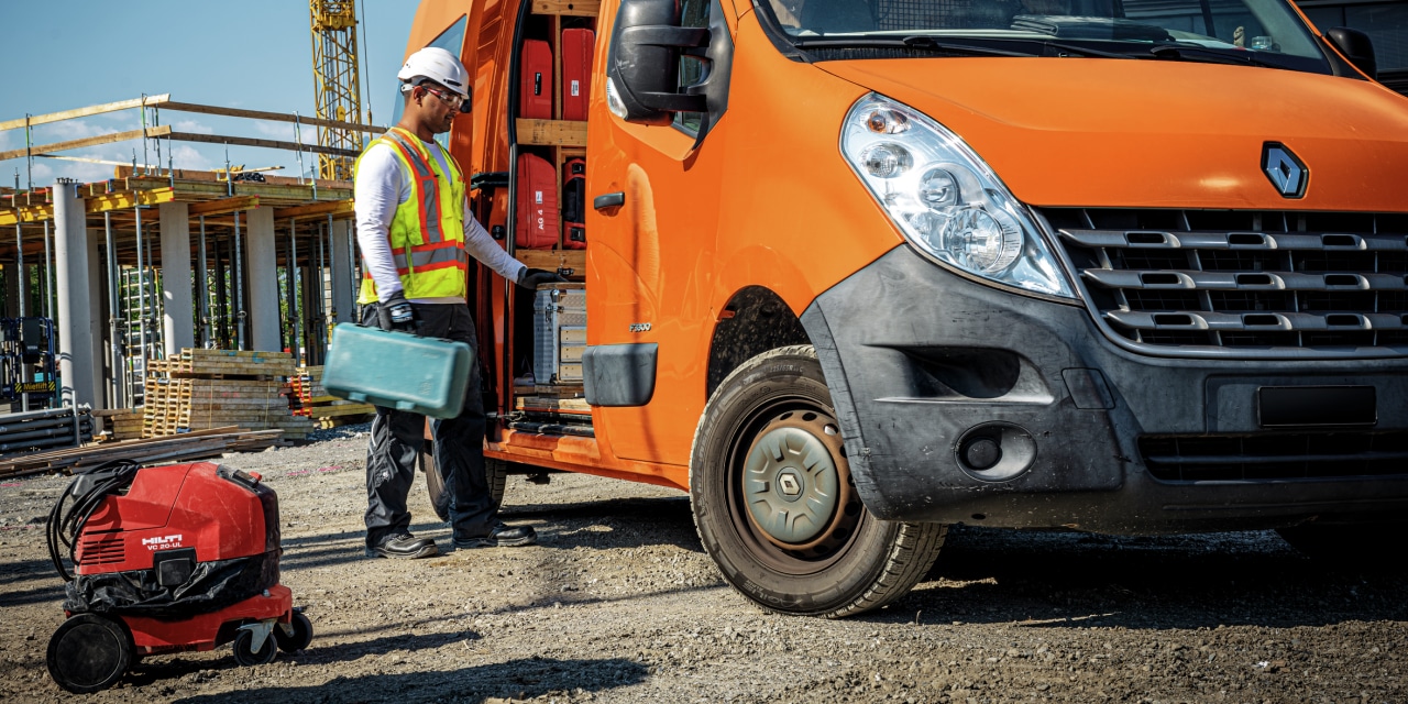 Worker unloading equipment from their van