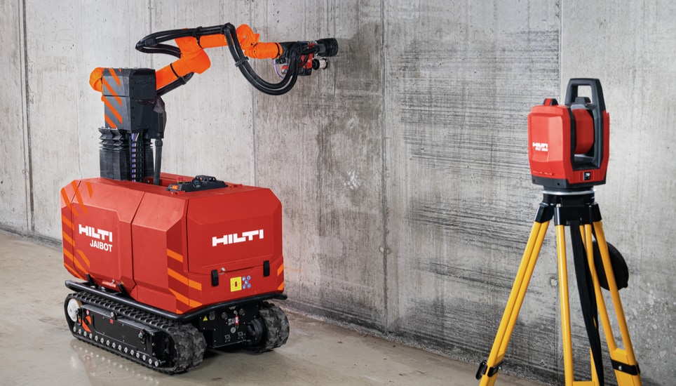 Concrete ceiling and construction robot drilling on a jobsite.