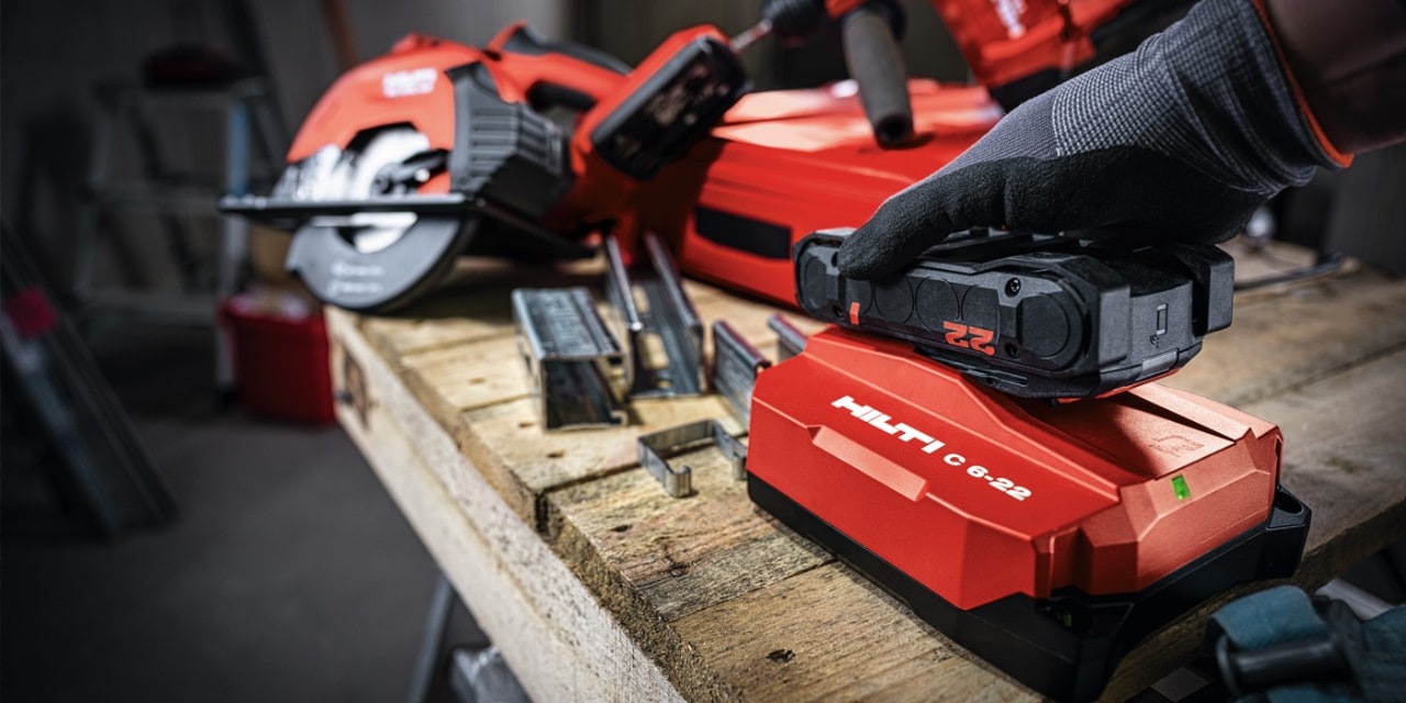 Hilti charger charges a battery on a job site