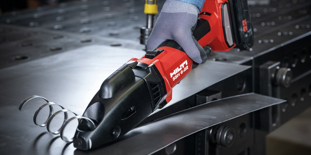 man using metal shear
