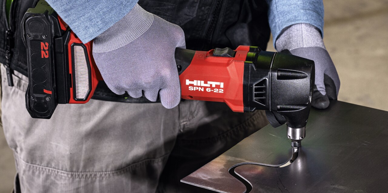 man using cordless nibbler