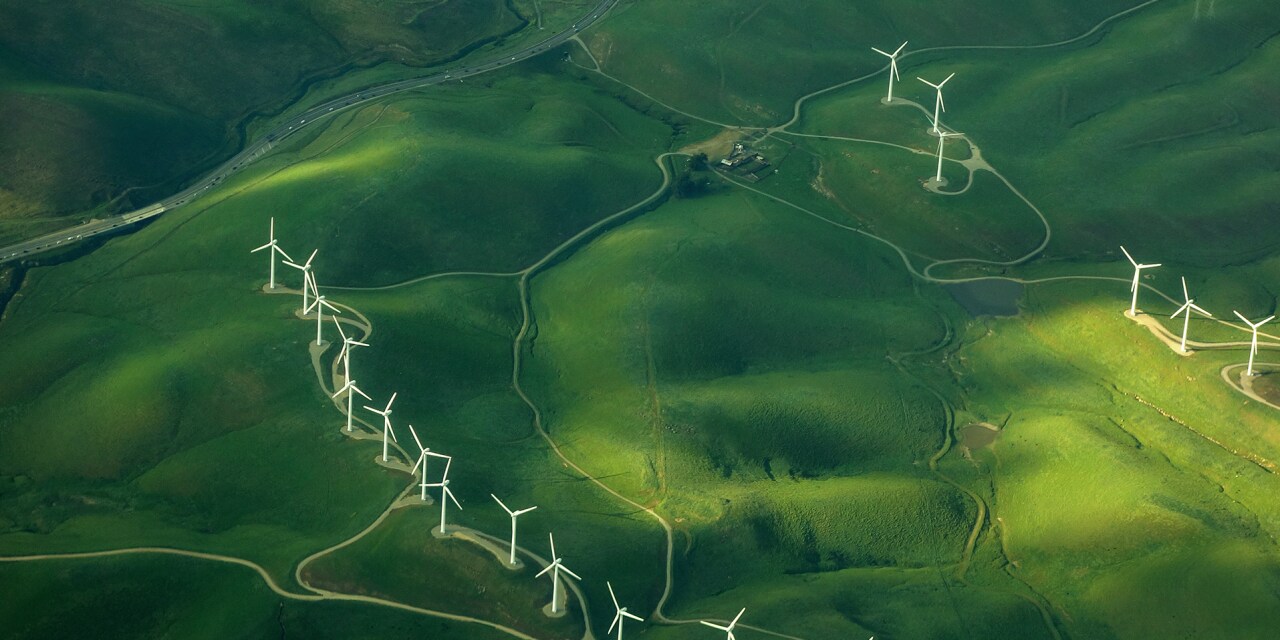 beautiful green aerial view of windmill farm providing eco-friendly energy sustainabilityÂ 