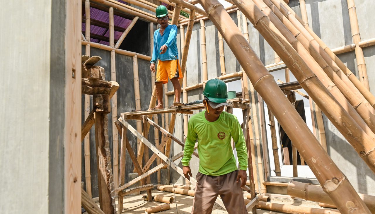 Workers build an orphanage using bamboo-cement technology in Batangas.