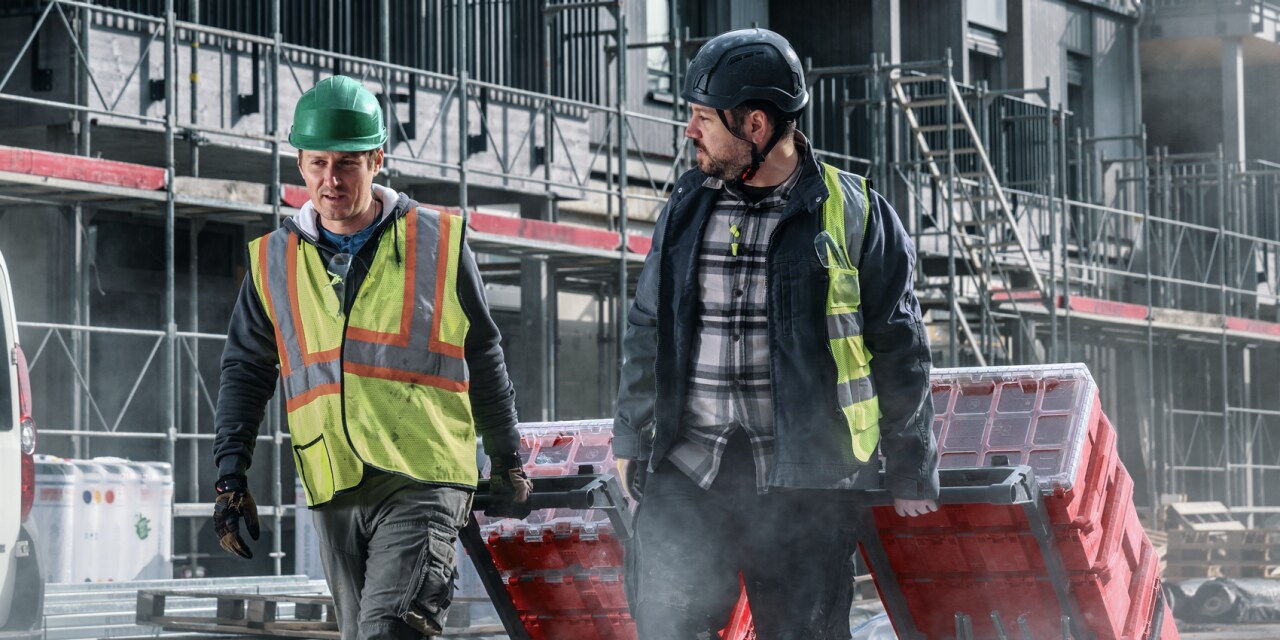 two workers walking under sunshine on the jobsite