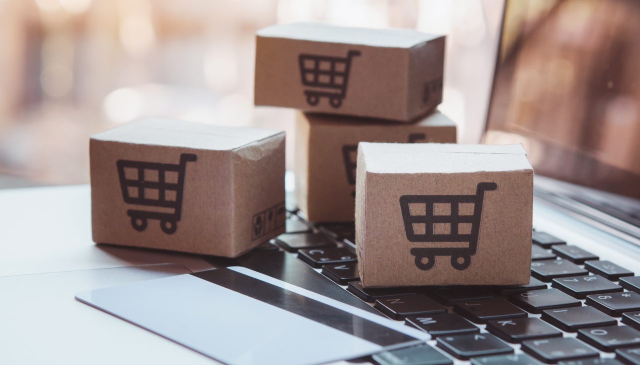 Shopping online. Credit card and cardboard box with a shopping cart logo on laptop keyboard. Shopping service on The online web. offers home delivery