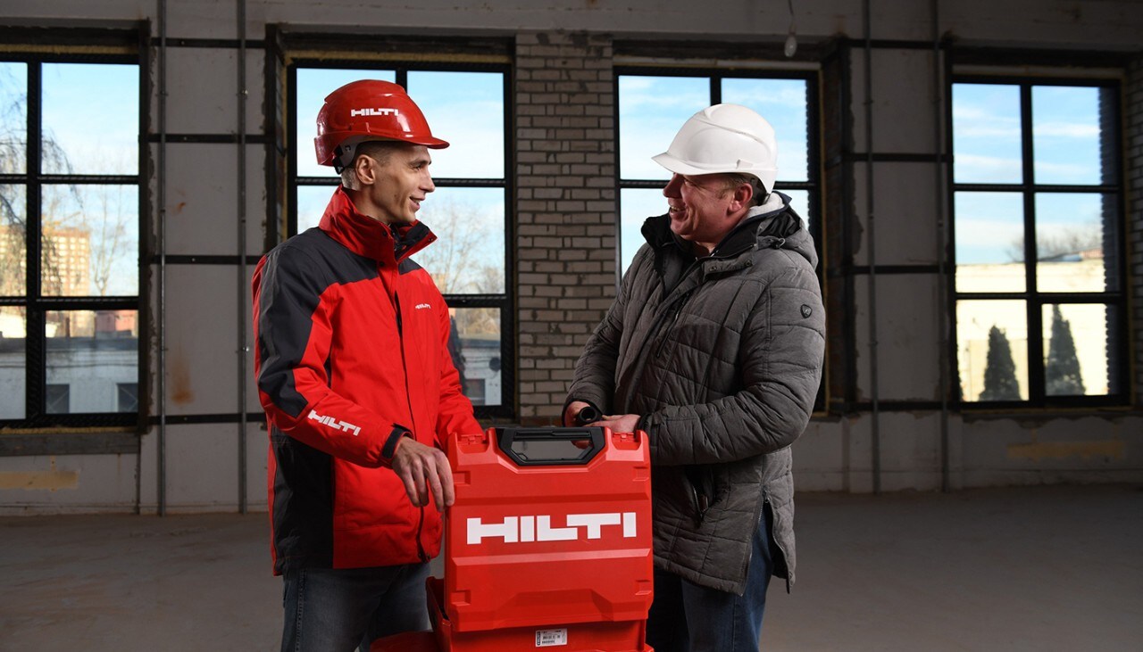 Un chargé d'affaires Hilti et son client avec une mallette Hilti