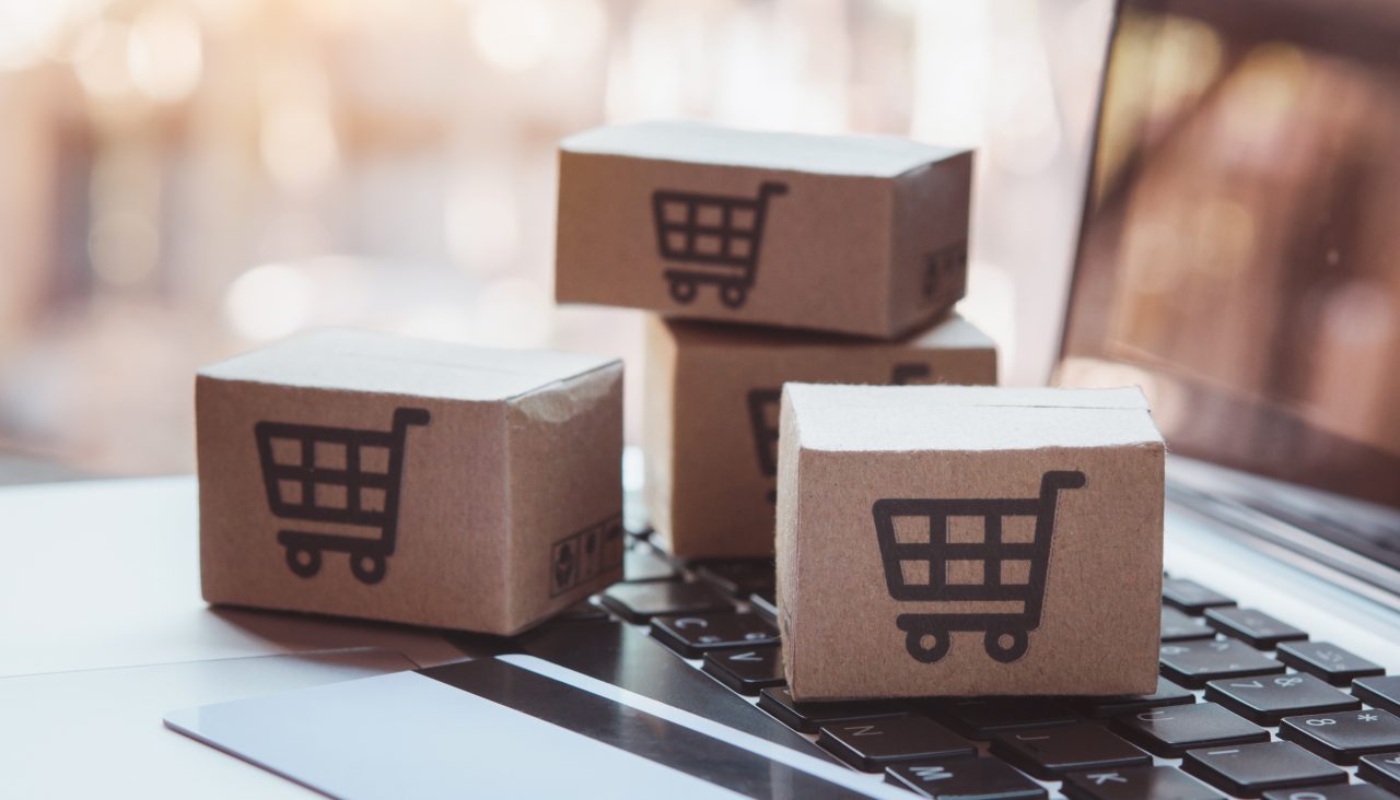 Shopping online. Credit card and cardboard box with a shopping cart logo on laptop keyboard. Shopping service on The online web. offers home delivery