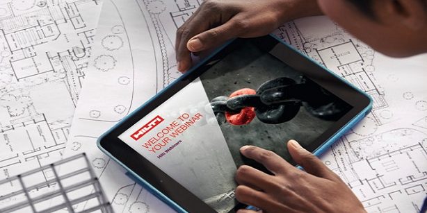 Cropped shot of a young architect using her digital tablet to work on building plans