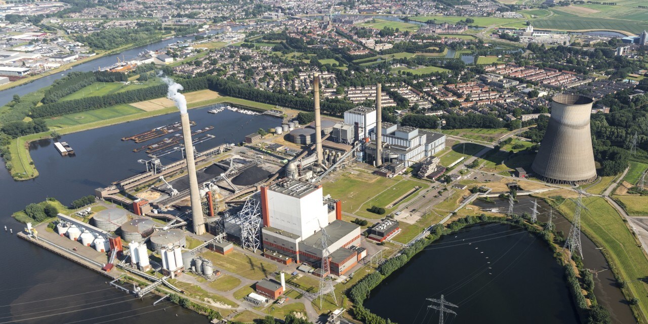 19 July 2016, Geertruidenberg, Holland. Aerial view of the AMERCENTRALE, a coal and biomass fired Essent powerplant. It's located at the river Amer. In the back the town of GEERTRUIDENBERG. 