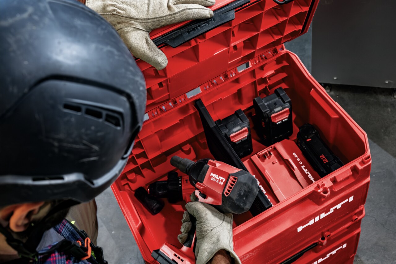 Overhead view of a man opening the tools compartment of the Prokit Portrait