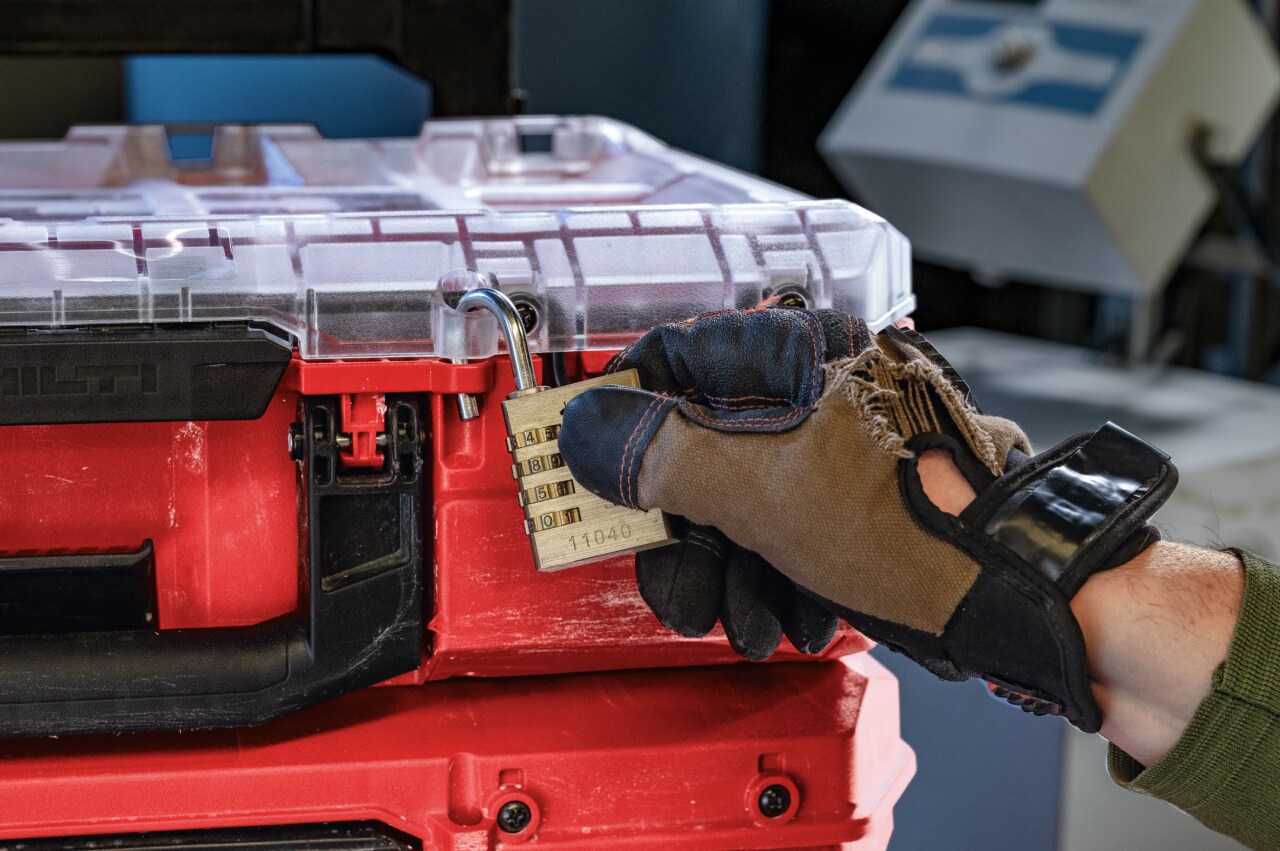 Hand on padlock on Prokit case