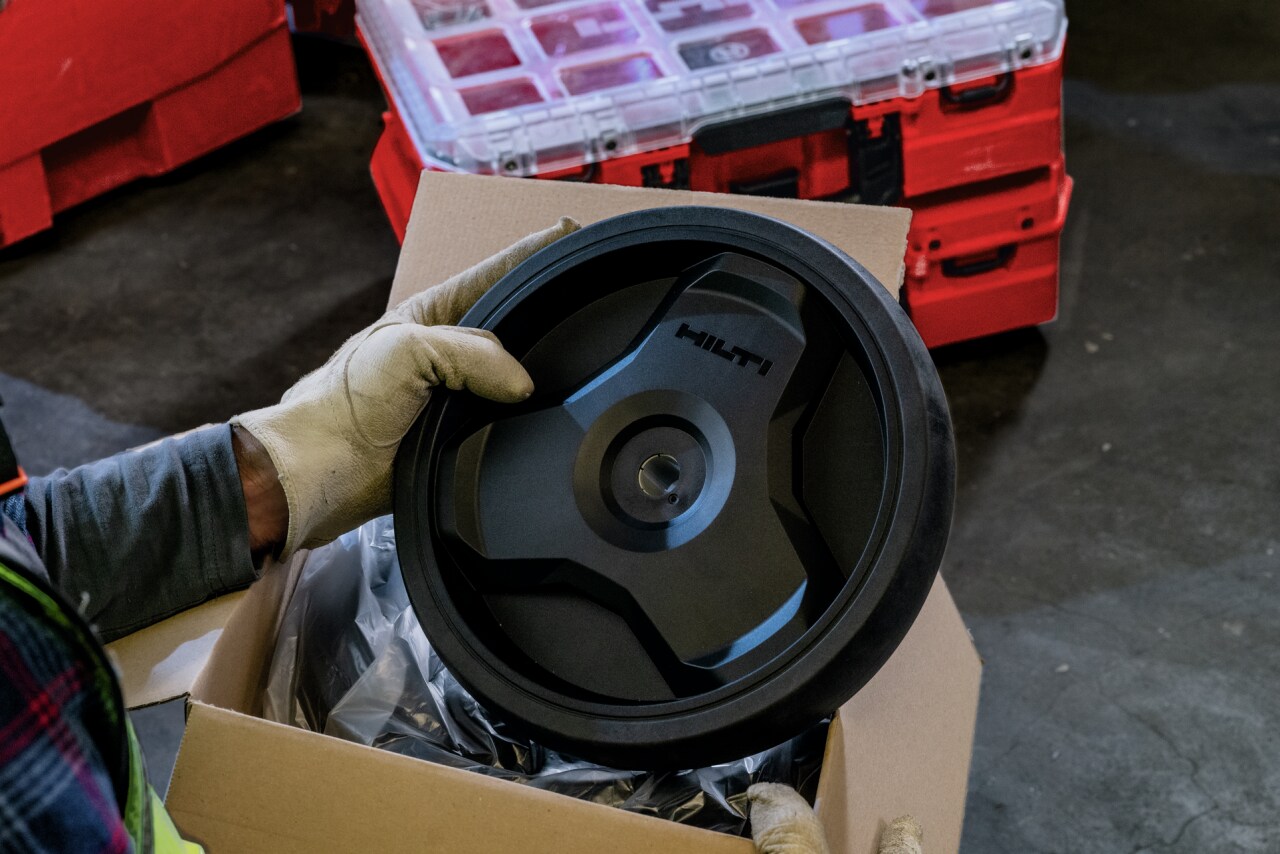 A man hold a replacement ProKit wheel while the ProKit features in the background