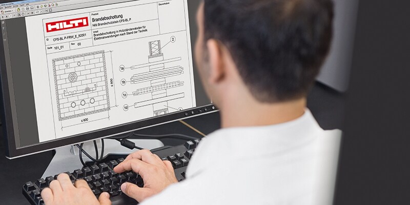 Close up rear view of a mature student using computer in the computer room