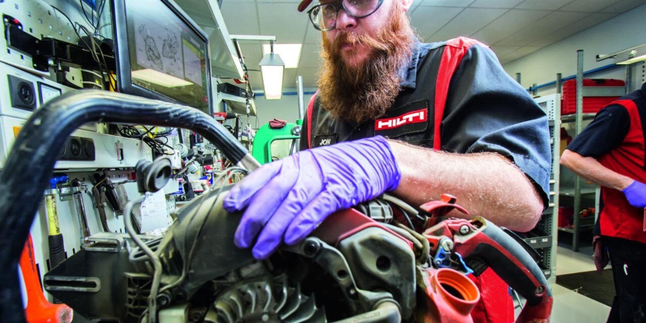 a man works on a gas saw in a Hilti repair center