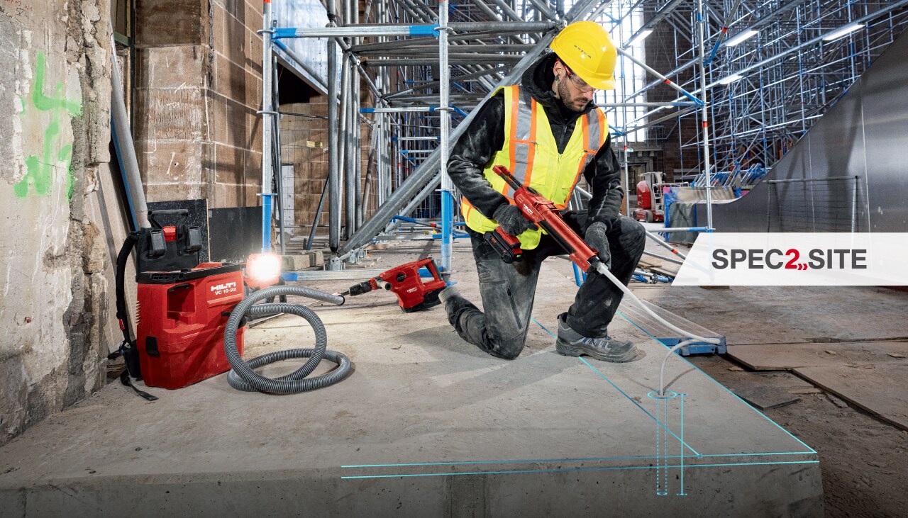 A worker injects epoxy anchor into a hole using a Hilti dispenser