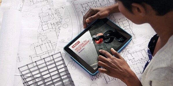 Cropped shot of a young architect using her digital tablet to work on building plans
