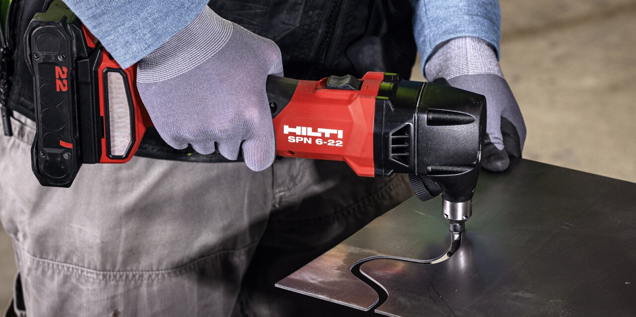 man using cordless nibbler